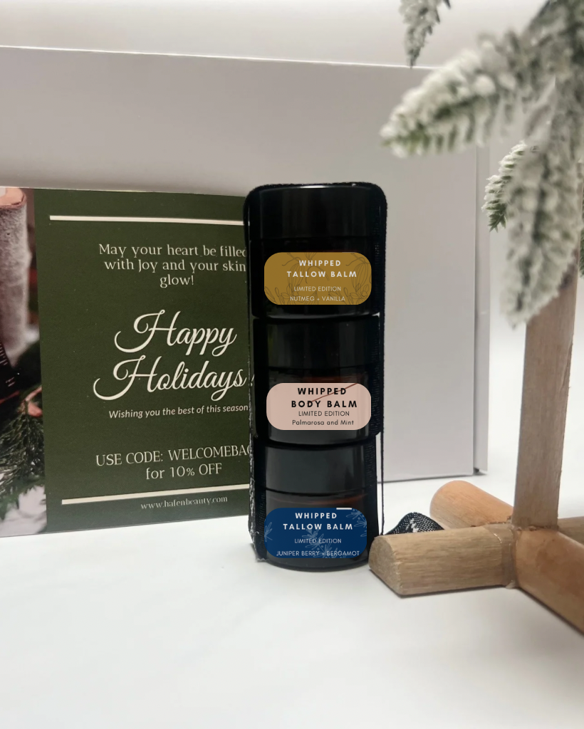 Whipped tallow balm bottle with holiday-themed card and decorative elements
